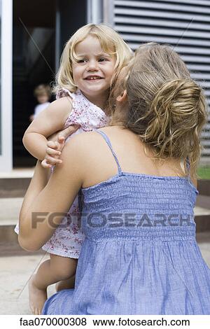Stock Photo - Mother embracing young daughter. Fotosearch