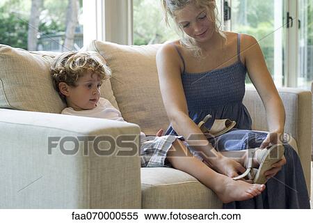 Mother helping young son put on shoes View Large Photo Image Stock Photography - Mother helping young son put on shoes. Fotosearch