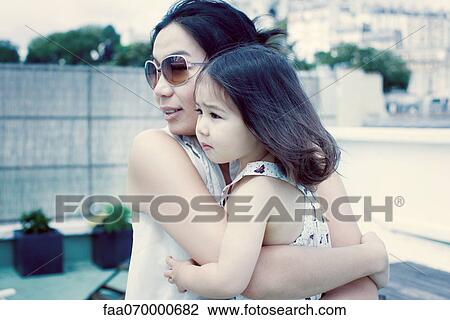 Mother holding little girl View Large Photo Image Stock Image - Mother holding little girl. Fotosearch