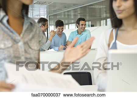 Office workers laughing together View Large Photo Image Stock Photo - Office workers laughing together. Fotosearch