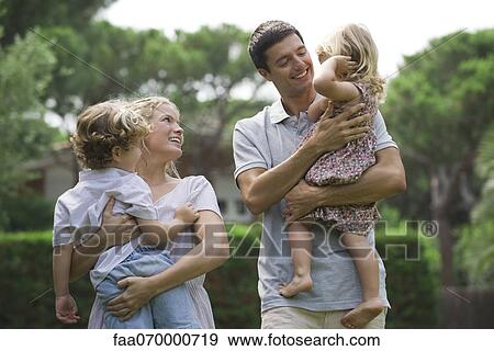 Parents carrying children outdoors View Large Photo Image Stock Photo - Parents carrying children outdoors. Fotosearch