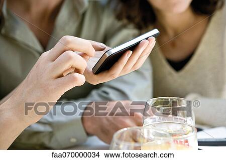 Person using cell phone, cropped View Large Photo Image Picture - Person using cell phone, cropped. Fotosearch