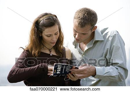 Tourist couple consulting guidebook View Large Photo Image Stock Image - Tourist couple consulting guidebook. Fotosearch