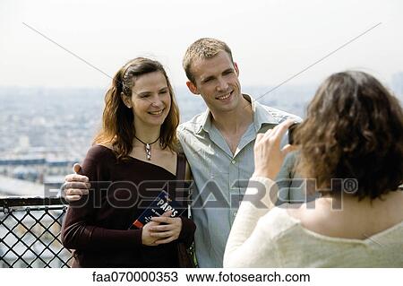 Tourist couple posing for photograph at scenic lookout View Large Photo Image Stock Image - Tourist couple posing for photograph at scenic lookout. Fotosearch