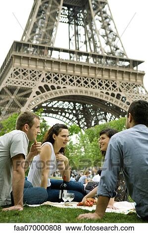 Tourists enjoying picnic at Eiffel Tower, Paris, France View Large Photo Image Stock Photo - Tourists enjoying picnic at Eiffel Tower, Paris, France. Fotosearch