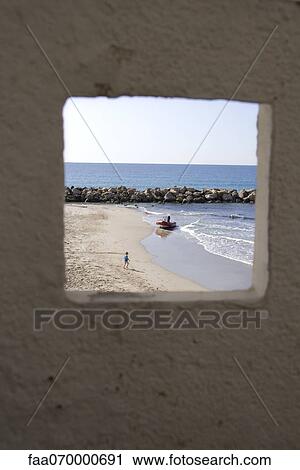 Stock Image - View of beach and ocean through window. Fotosearch