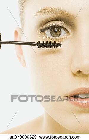 Woman applying mascara, close-up View Large Photo Image Stock Photo - Woman applying mascara, close-up. Fotosearch