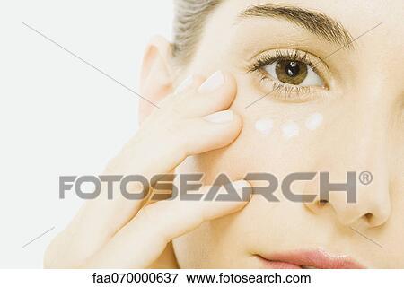 Woman applying undereye cream, close-up, cropped View Large Photo Image Stock Photo - Woman applying undereye cream, close-up, cropped. Fotosearch
