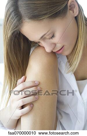 Woman caressing leg, eyes closed View Large Photo Image Stock Image - Woman caressing leg, eyes closed. Fotosearch