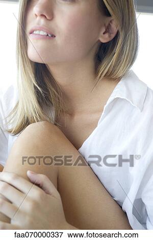 Woman daydreaming, touching leg, cropped View Large Photo Image Stock Photo - Woman daydreaming, touching leg, cropped. Fotosearch