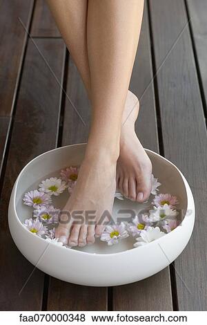 Stock Photo - Woman enjoying relaxing foot bath. Fotosearch