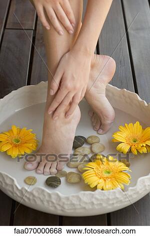 Stock Photo - Woman enjoying relaxing foot bath. Fotosearch