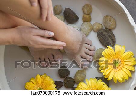 Stock Photography - Woman enjoying relaxing foot bath. Fotosearch