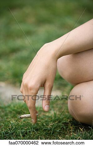 Woman holding a marijuana joint, cropped View Large Photo Image Stock Image - Woman holding a marijuana joint, cropped. Fotosearch
