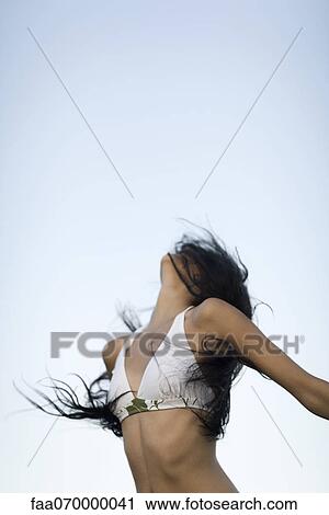 Woman in bikini throwing head back, hair covering face View Large Photo Image Stock Image - Woman in bikini throwing head back, hair covering face. Fotosearch
