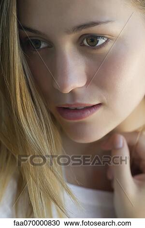 Stock Image - Woman looking away dreamily, portrait. Fotosearch