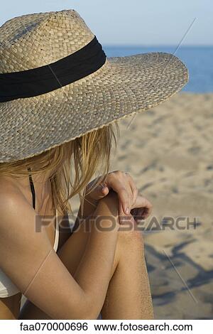 Woman sitting on beach, looking at view View Large Photo Image Stock Photograph - Woman sitting on beach, looking at view. Fotosearch