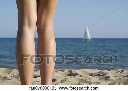 Woman standing on beach, cropped rear view View Large Photo Image Stock Photography - Woman standing on beach, cropped rear view. Fotosearch