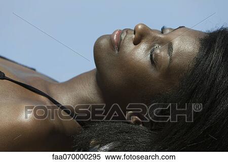 Woman sunbathing View Large Photo Image Stock Photography - Woman sunbathing. Fotosearch