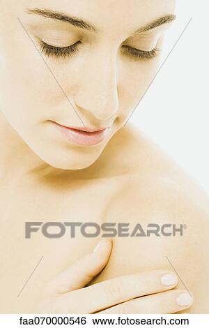Stock Photograph - Woman touching bare shoulder, close-up. Fotosearch
