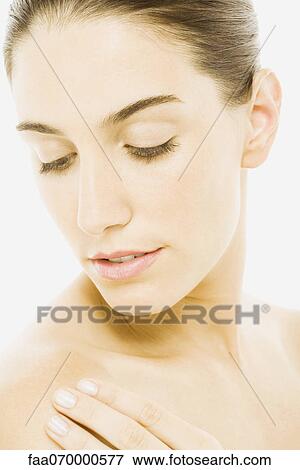 Stock Photo - Woman touching bare shoulder, portrait. Fotosearch