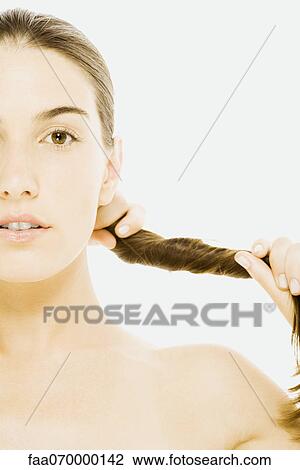 Woman twisting hair View Large Photo Image Stock Image - Woman twisting hair. Fotosearch