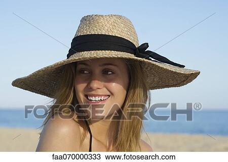 Woman wearing sun hat at the beach, portrait View Large Photo Image Stock Image - Woman wearing sun hat at the beach, portrait. Fotosearch