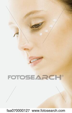 Woman with dots of undereye cream applied beneath eye, close-up View Large Photo Image Stock Photo - Woman with dots of undereye cream applied beneath eye, close-up. Fotosearch