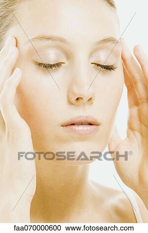 Woman with eyes closed massaging temples View Large Photo Image Stock Image - Woman with eyes closed massaging temples. Fotosearch