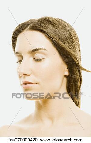 Stock Image - Woman with eyes closed, portrait. Fotosearch