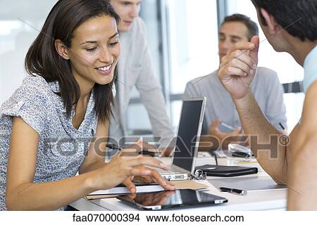 Picture - Woman working on digital tablet in office. Fotosearch