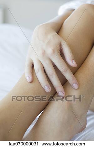 Woman's hand touching legs View Large Photo Image Stock Image - Woman's hand touching legs. Fotosearch