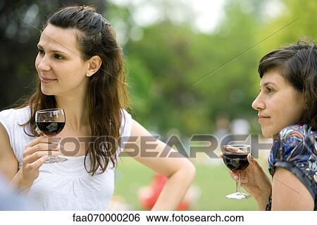 Women enjoying red wine outdoors View Large Photo Image Stock Photograph - Women enjoying red wine outdoors. Fotosearch