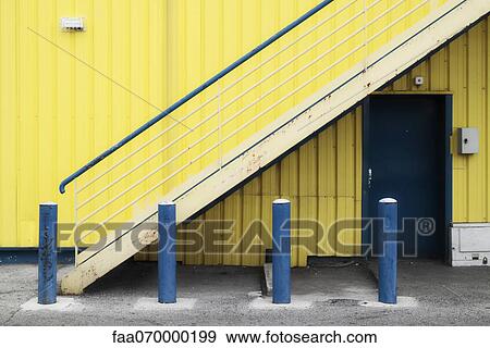 Yellow building, blue bollards View Large Photo Image Stock Photo - Yellow building, blue bollards. Fotosearch