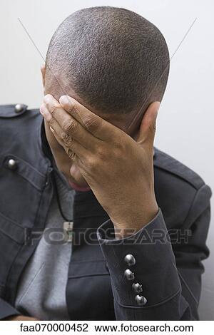 Young man covering face with hand View Large Photo Image Stock Image - Young man covering face with hand. Fotosearch