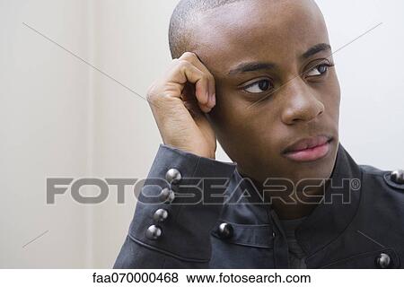 Young man looking away in thought, portrait View Large Photo Image Stock Photo - Young man looking away in thought, portrait. Fotosearch