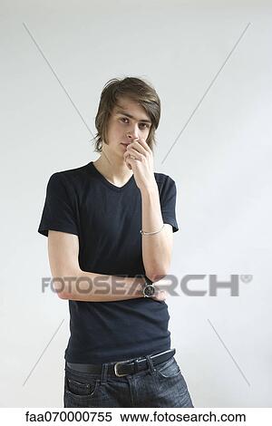 Young man looking pensively at camera, portrait View Large Photo Image Stock Photography - Young man looking pensively at camera, portrait. Fotosearch