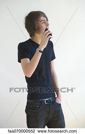 Stock Image - Young man talking on cell phone. Fotosearch