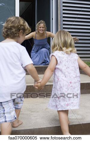 Young siblings holding hands, running toward mother View Large Photo Image Stock Photography - Young siblings holding hands, running toward mother. Fotosearch