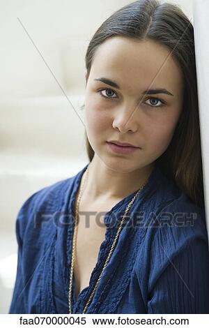 Young woman looking at camera, portrait View Large Photo Image Stock Photography - Young woman looking at camera, portrait. Fotosearch