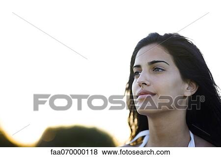 Young woman looking away contentedly, portrait View Large Photo Image Stock Photo - Young woman looking away contentedly, portrait. Fotosearch