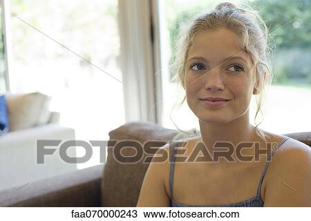 Young woman looking away in thought, portrait View Large Photo Image Stock Image - Young woman looking away in thought, portrait. Fotosearch