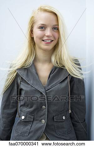 Young woman smiling at camera, portrait View Large Photo Image Stock Image - Young woman smiling at camera, portrait. Fotosearch