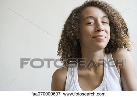 Stock Photo - Young woman smiling at camera, portrait. Fotosearch