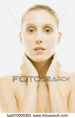 Young woman with bare shoulders, hands around neck and looking at camera, portrait View Large Photo Image Stock Image - Young woman with bare shoulders, hands around neck and looking at camera, portrait. Fotosearch