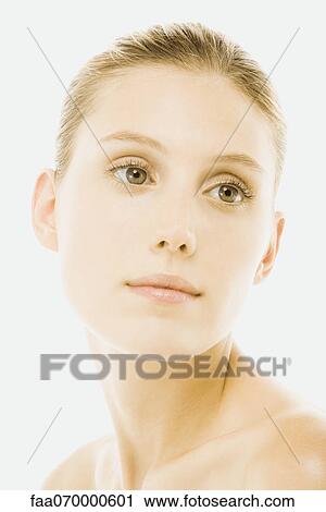 Stock Image - Young woman with bare shoulders, tilting head, portrait. Fotosearch