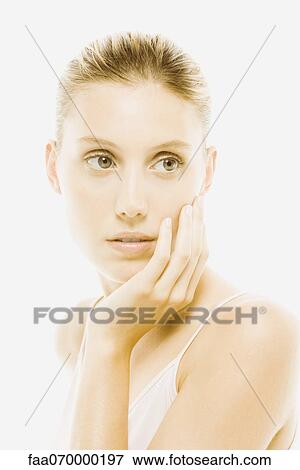 Young woman with hand under chin contemplatively looking away View Large Photo Image Stock Photo - Young woman with hand under chin contemplatively looking away. Fotosearch