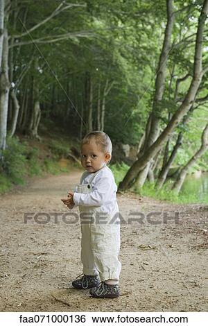 Baby girl standing in woods View Large Photo Image Stock Photograph - Baby girl standing in woods. Fotosearch