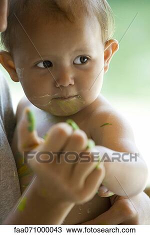 Stock Image - Baby touching mother's hand. Fotosearch