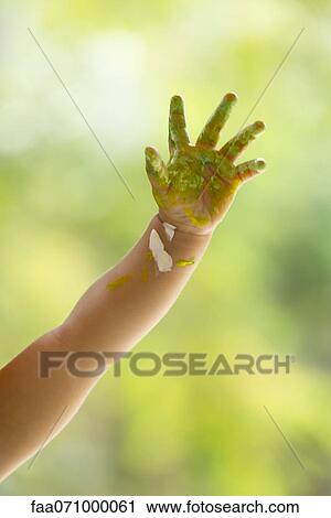Stock Image - Baby's hand covered with paint. Fotosearch